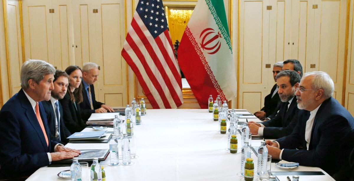 U.S. Secretary of State John F. Kerry, left, with Iranian Foreign Minister Mohammad Javad Zarif, right, in Vienna on Saturday.