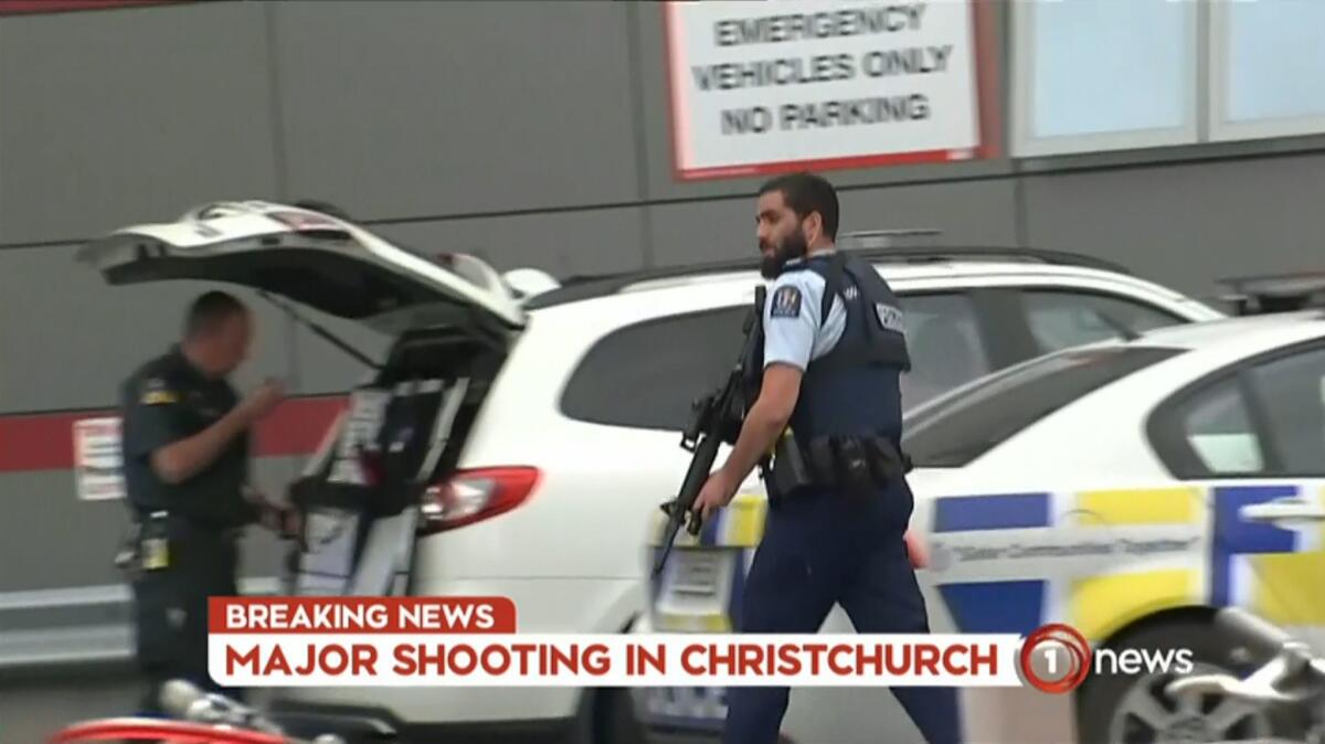 An image grab from TV New Zealand taken Friday shows an armed police officer at a hospital following the mosque shootings in Christchurch.