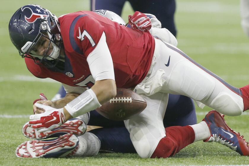 Texans quarterback Brian Hoyer fumbles the ball while being sacked by Patriots defensive lineman Jabaal Sheard in the fourth quarter.