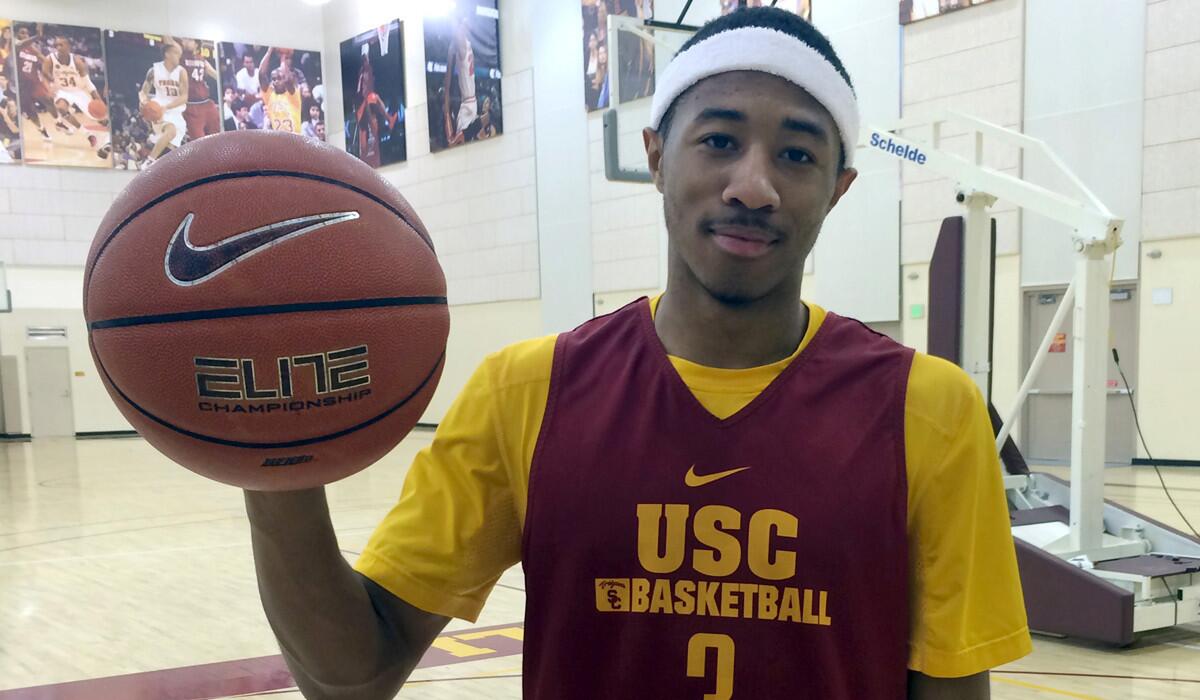 USC guard Elijah Stewart holds a Nike basketball during practice on Tuesday.