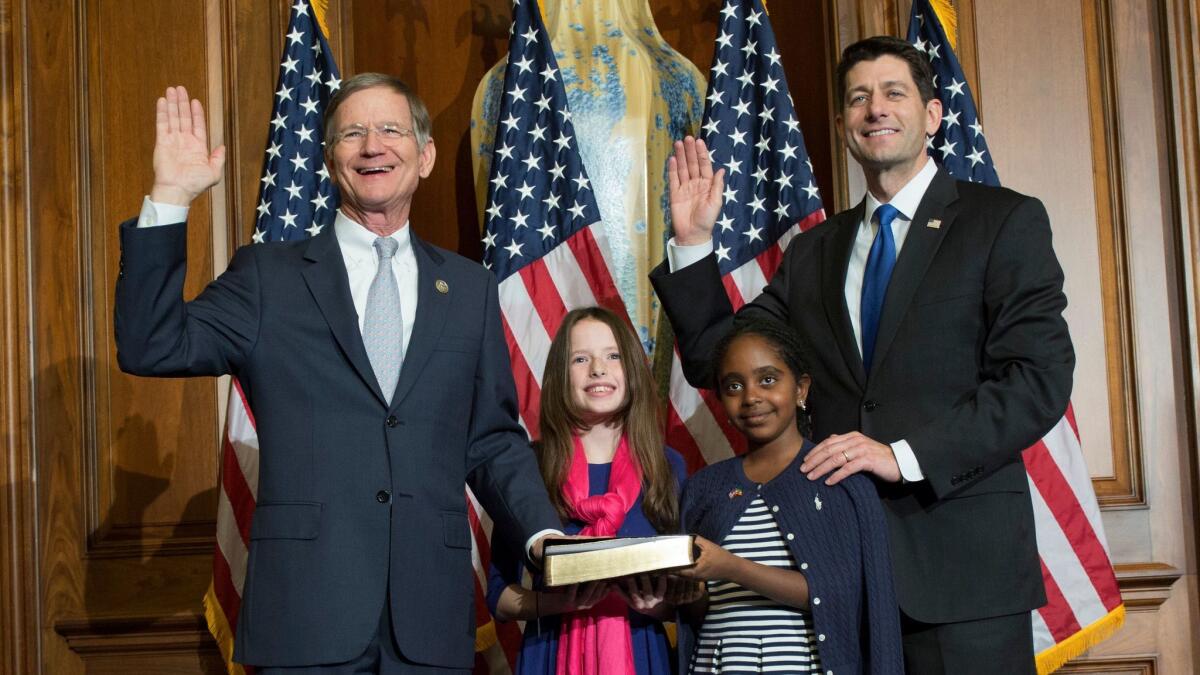 Rep. Lamar Smith (R-Texas), left, is sworn in to his new term by House Speaker Paul Ryan in January. Oil and gas contributors have directed nearly $700,000 in Smith’s direction since he entered in Congress in 1987.