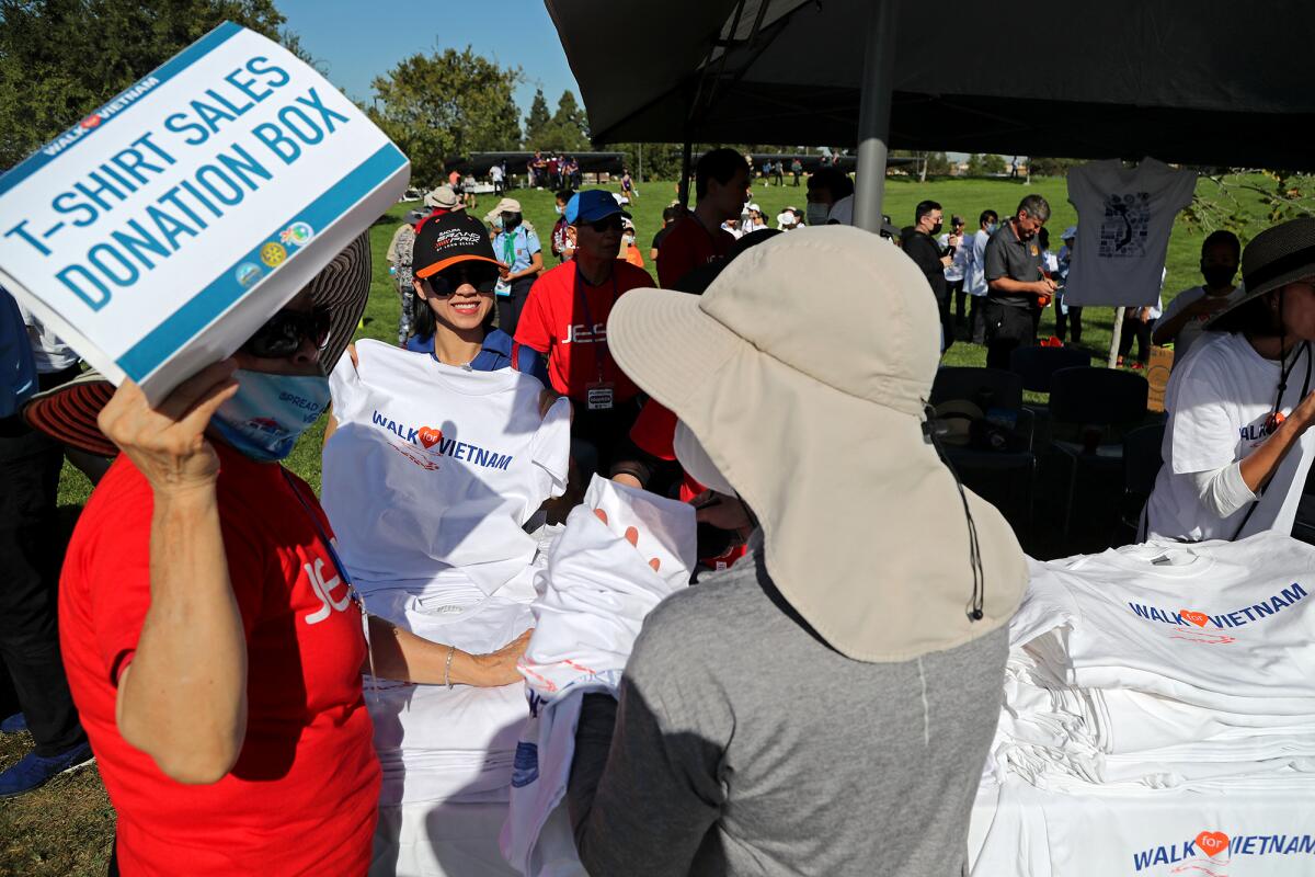 Rotary Club volunteers hand out T-shirts for donations during the "Walk for Vietnam" event on Oct. 2 at Mile Square Park.