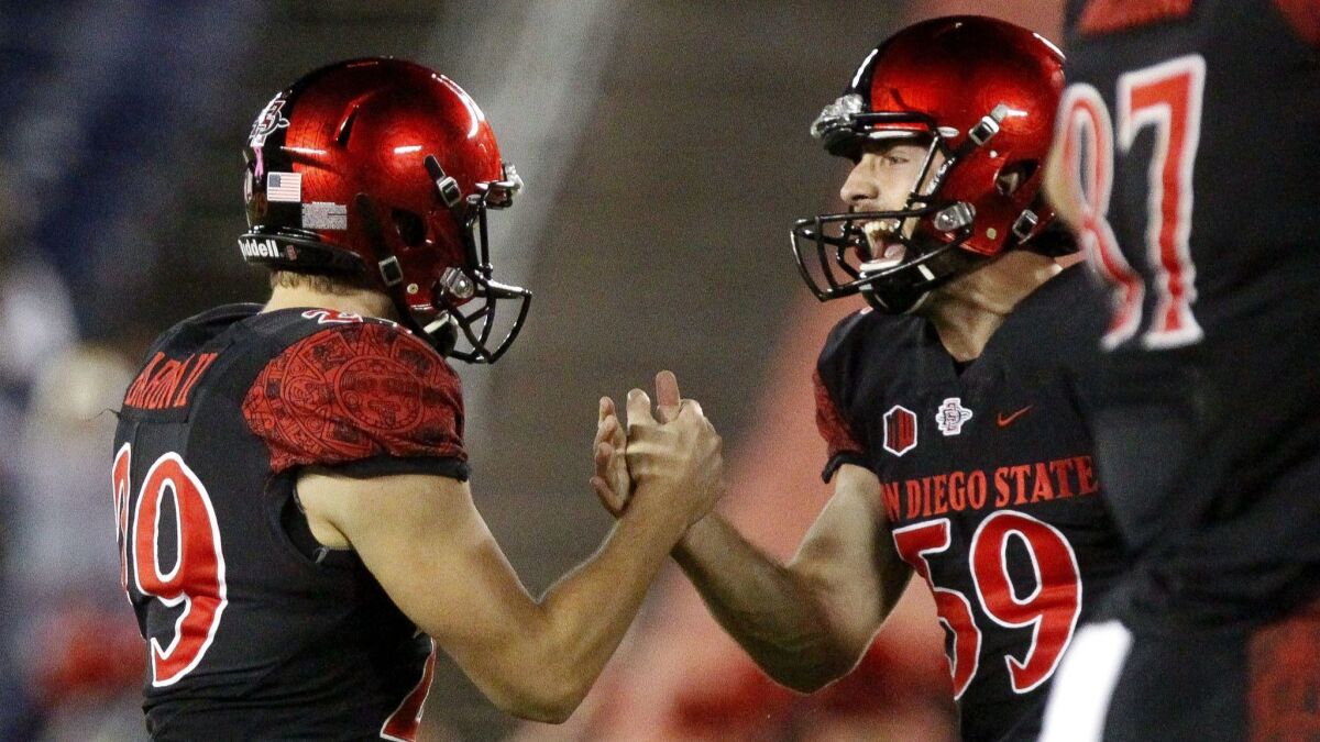 San Diego State place-kicker John Baron II (left) celebrates with holder Brandon Heicklen after Baron booted a 51-yard field goal in the fourth quarter