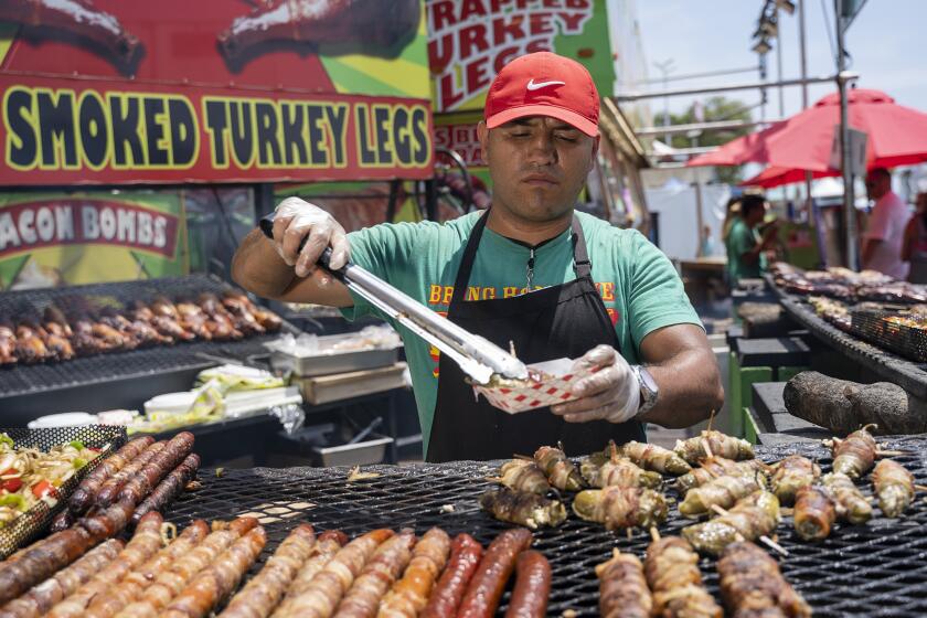 Antonio Sotomayor prepares a bacon wrapped jalapeno on Thursday, June 22.