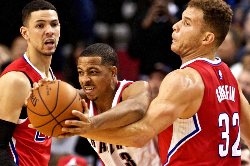 Trail Blazers guard C.J. McCollum tries to make a play against the double-team defense of Clippers forward Blake Griffin and guard Austin Rivers during a Nov. 20, 2015, game in Portland.