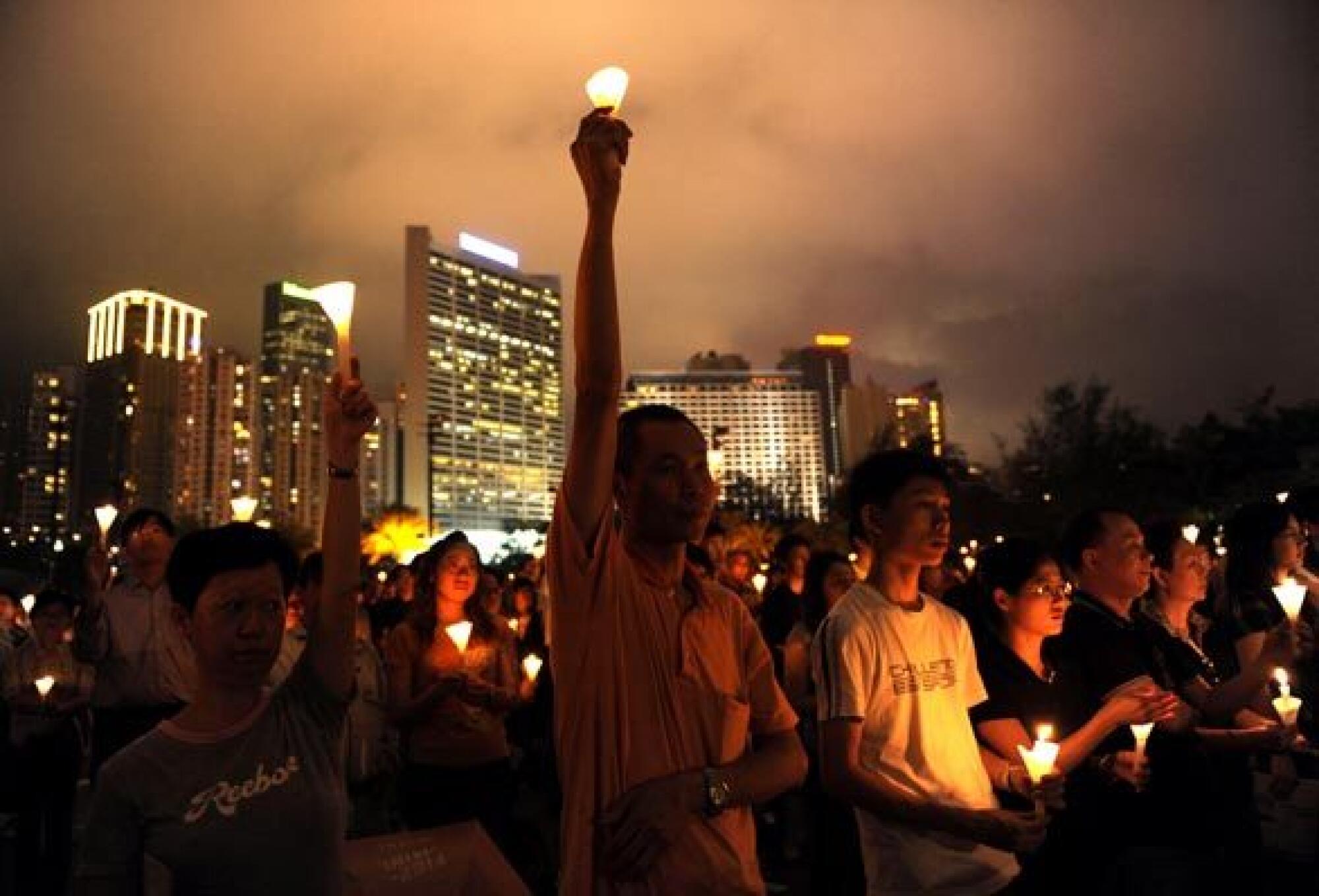 A man holds a candle as tens of thousands people stage a candlelight vigil at Hong Kong's Victoria Park