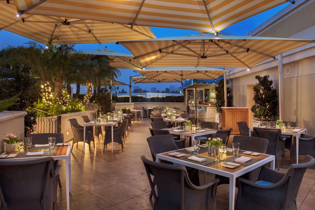 rooftop dining area with striped umbrellas 