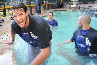 Dodgers' Clayton Kershaw celebrates in the pool with teammates after winning the division in Arizona on Sept. 19, 2013. 