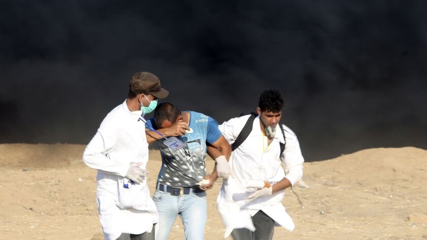 Medics help a protester exposed to tear gas fired by Israeli troops during a protest along the Gaza-Israel border on Friday. Israel alleges some medics and aid workers are actually Hamas fighters.