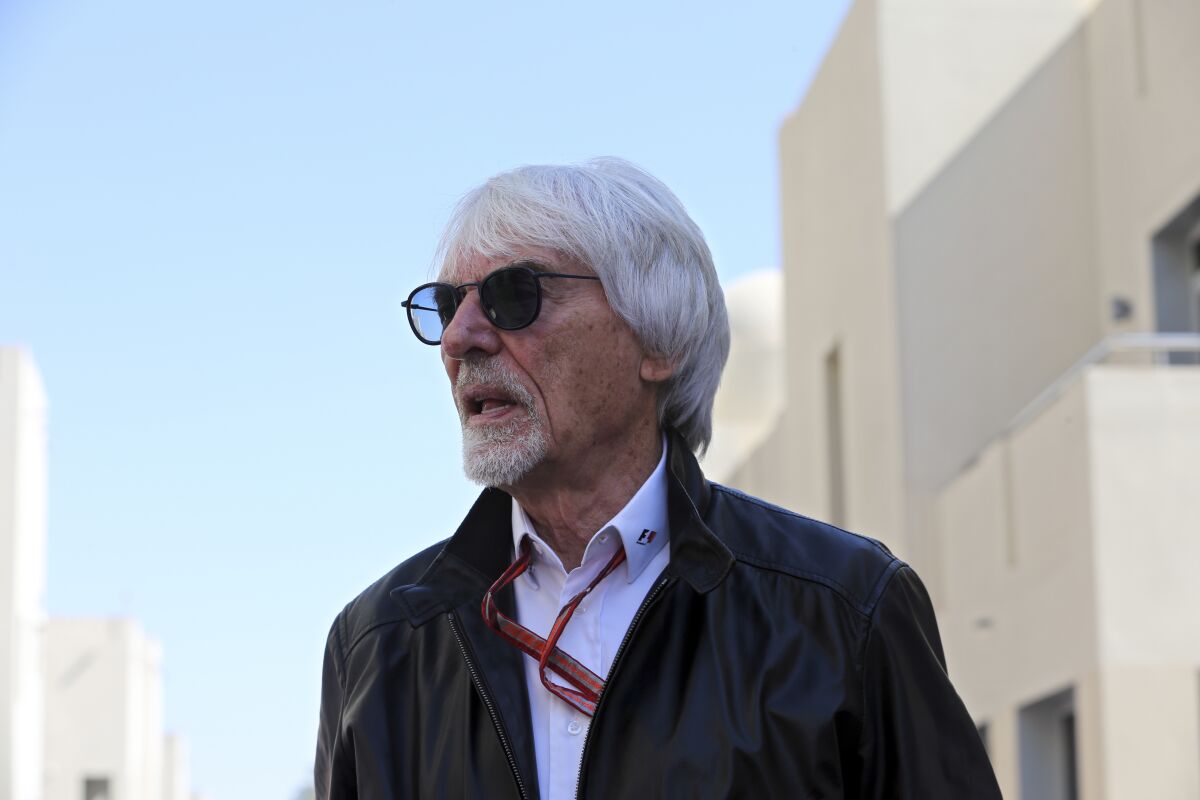 FILE - Former Formula One boss Bernie Ecclestone walks in the paddock during the first free practice at the Yas Marina racetrack in Abu Dhabi, United Arab Emirates, Friday Nov. 23, 2018. British prosecutors say former Formula One boss Bernie Ecclestone will be charged with fraud by false representation following a government investigation into his overseas assets. (AP Photo/Kamran Jebreili, File)