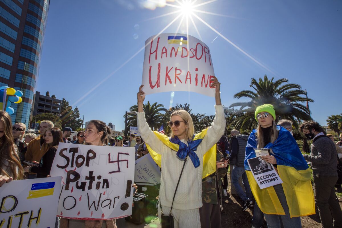 Protesters in Westwood hold signs reading "Hands Off Ukraine" and "Stop Putin"