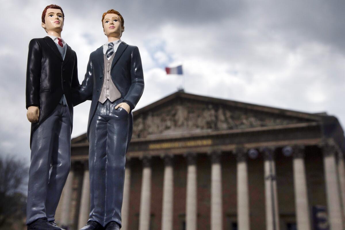 Plastic figurines set up in front of the Palais Bourbon, the seat of the French National Assembly.