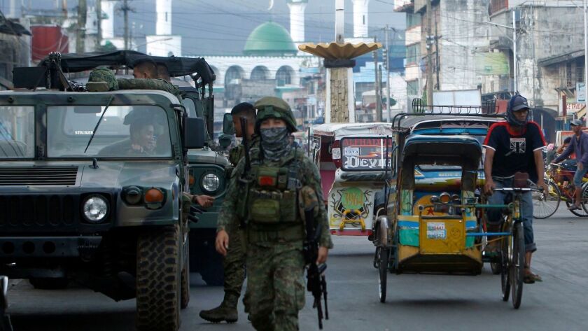 Philippine government troops conduct a patrol in Jolo town on the southern island of Sulu this month during a referendum on a new autonomous region for the southern Philippines.