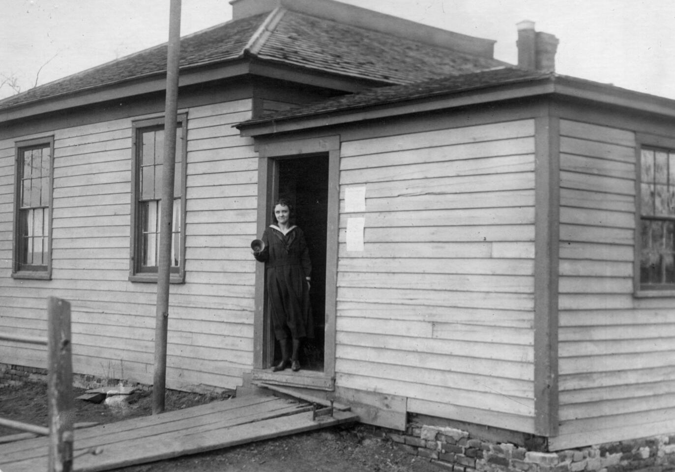 April 10, 1922: Teacher Esther Miller stands outside Elk Grove school district 56, which is 85 years old and the oldest in Cook County. The enrollment was 10 boys and four girls.