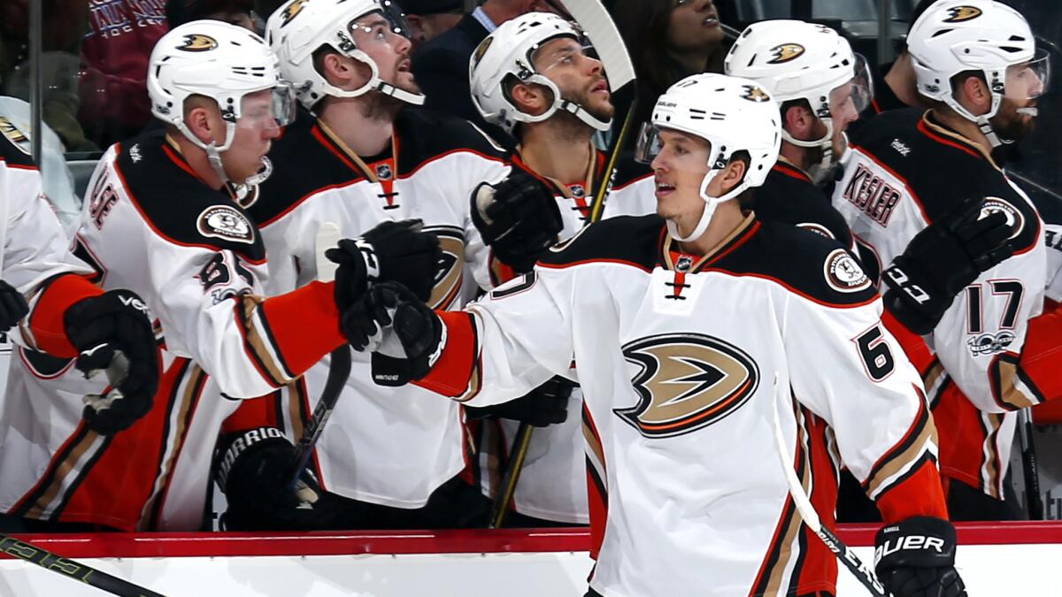 Ducks center Rickard Rakell is congratulated by teammates as he returns to the bench after scoring against the Avalanche during the first period Thursday.