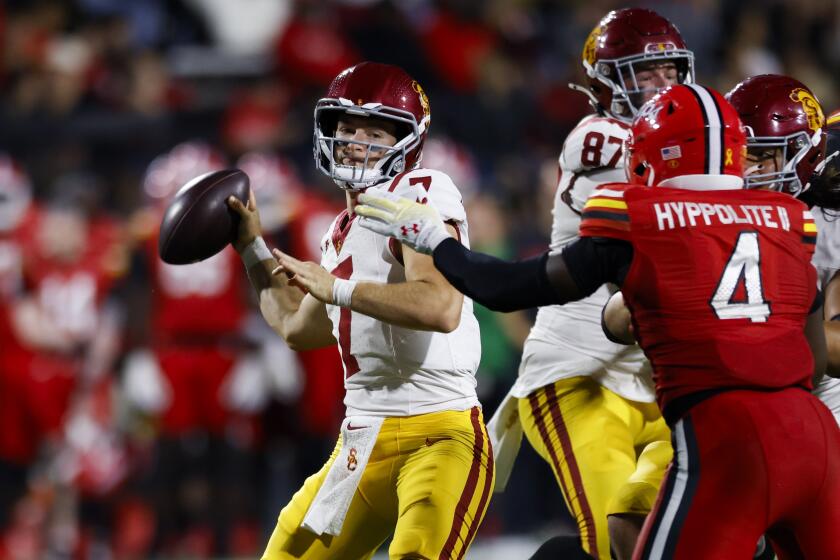 Southern California quarterback Miller Moss (7) is pressured by Maryland linebacker Ruben Hyppolite.