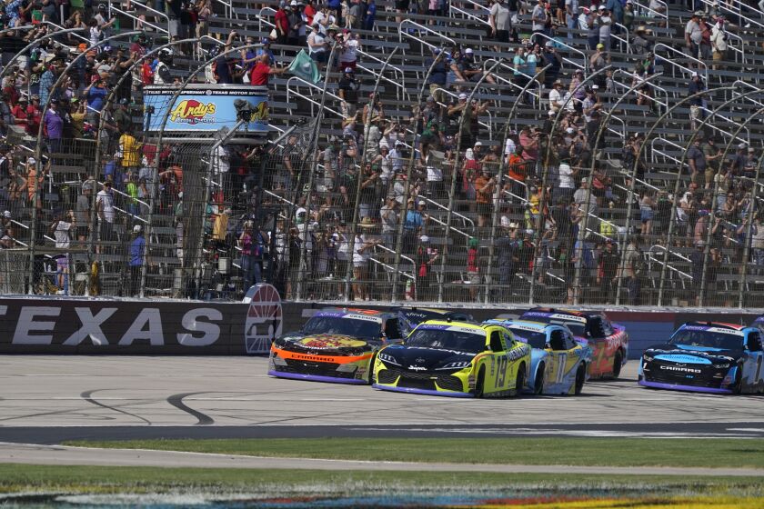 The green flag waves starting the NASCAR Xfinity Series auto race at Texas Motor Speedway in Fort Worth, Texas, Saturday, Sept. 24, 2022. (AP Photo/LM Otero)