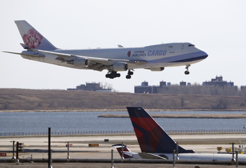 FILE - A China Airlines cargo jet lands at John F. Kennedy International Airport, Saturday, March 14, 2020, in New York. Verizon and AT&T have rejected a request by the U.S. government to delay the rollout of next-generation wireless technology. A joint letter Sunday, Jan. 2, 2022, from the telecommunications giants to U.S. Transportation Secretary Pete Buttigieg and the head of the Federal Aviation Administration, sought to dismiss concerns brought by U.S. airlines that a new 5G wireless service could harm aviation. (AP Photo/Kathy Willens, File)