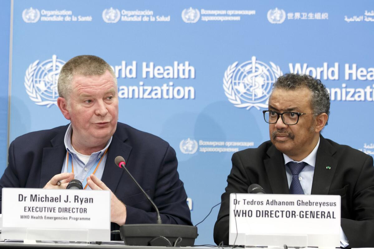 FILE - In this Monday, Feb. 24, 2020 file photo, Michael Ryan, left, Executive Director of WHO's Health Emergencies programme, next to Tedros Adhanom Ghebreyesus, right, Director General of the World Health Organization (WHO), addresses a press conference about the update on COVID-19 at the World Health Organization headquarters in Geneva, Switzerland. The emergencies chief of the World Health Organization said on Monday March 1, 2021, it was “premature” and “unrealistic” to think the pandemic might be stopped by the end of the year, but that the recent arrival of effective vaccines could at least help dramatically reduce hospitalizations and death. (Salvatore Di Nolfi/Keystone via AP, File)