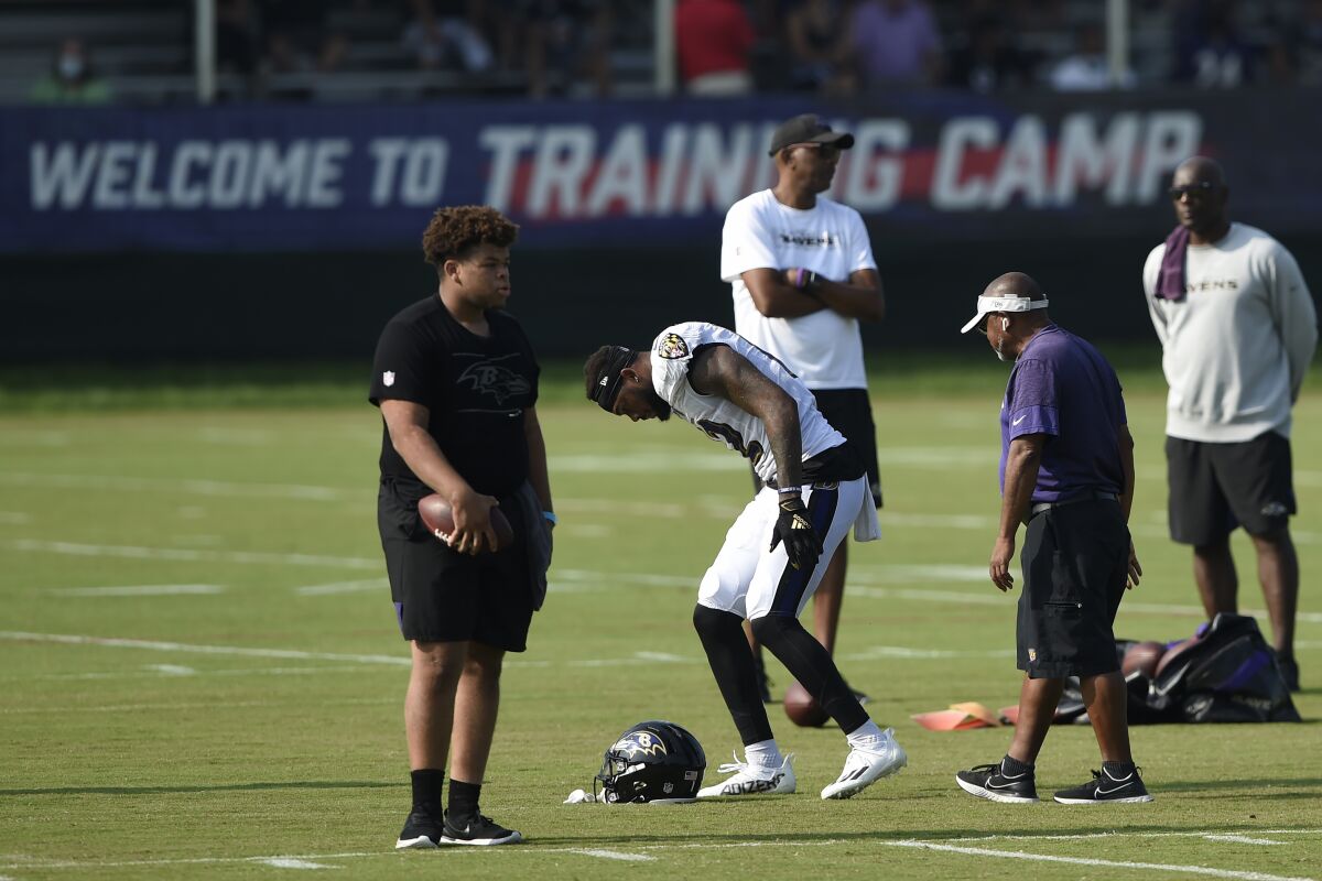 Baltimore Ravens' Rashod Bateman limps off the field during an NFL football practice, Tuesday, Aug. 10, 2021 in Owings Mills, Md.(AP Photo/Gail Burton)