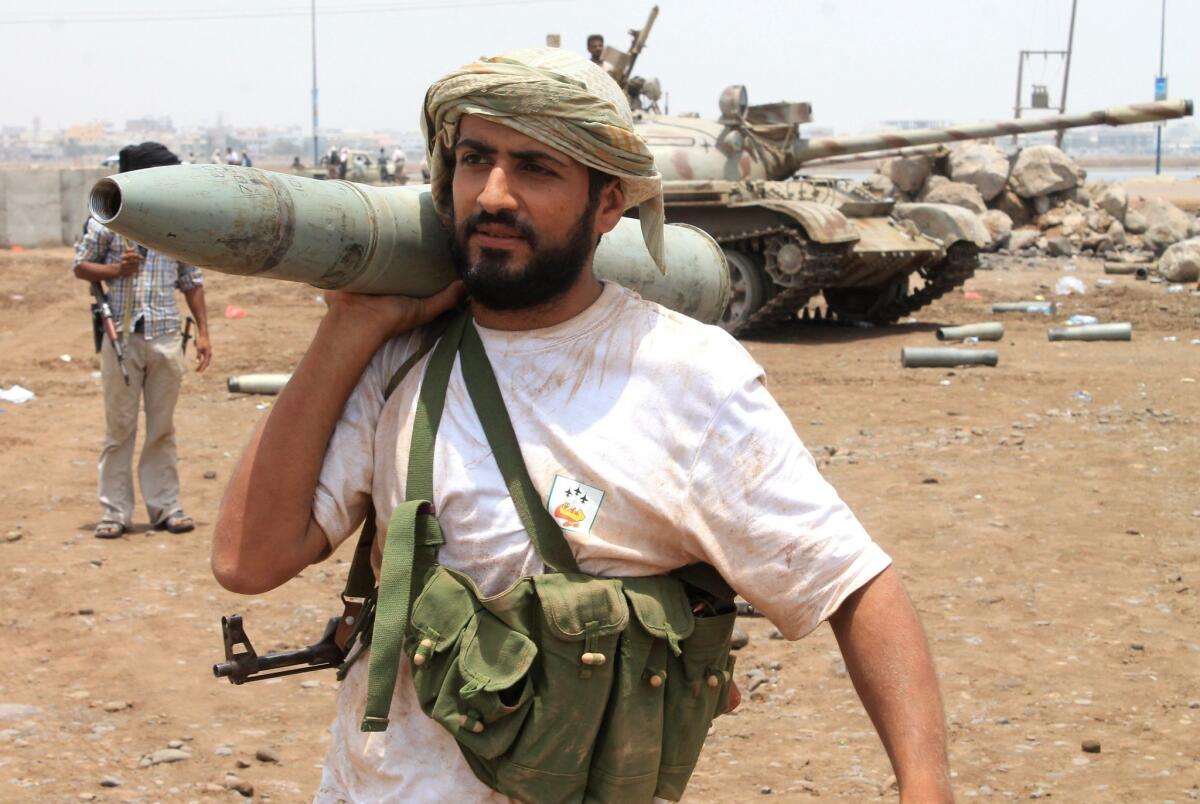 A Yemeni supporter of the separatist Southern Movement rests a tank shell on his shoulder in the city of Aden on April 6.