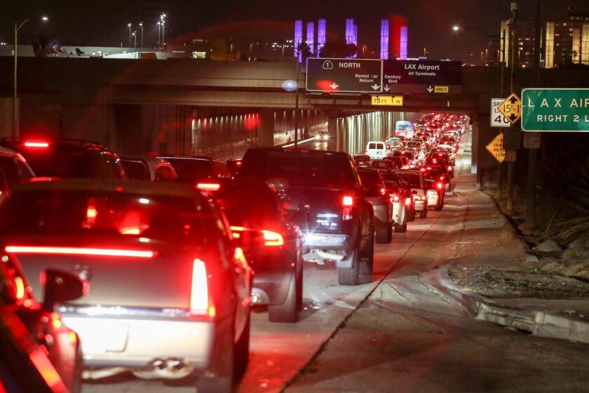 Motorists stop in a traffic backup at Los Angeles International Airport, Sunday, Aug. 28, 2016. Reports of a gunman opening fire that turned out to be false caused panicked evacuations at Los Angeles International Airport on Sunday night, while flights to and from the airport were delayed. A search through terminals brought no evidence of a gunman or shots fired, Los Angeles police spokesman Andy Neiman said. (AP Photo/Ringo H.W. Chiu)