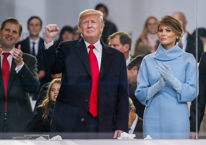 President Donald Trump stands with First Lady Melania Trump during his inauguration Friday.