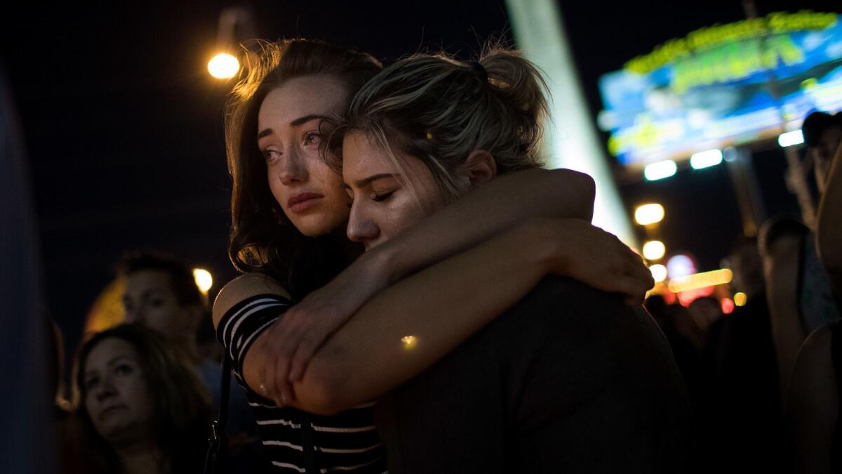 The day after the shooting, people gathered at a candlelight vigil to mourn the victims.