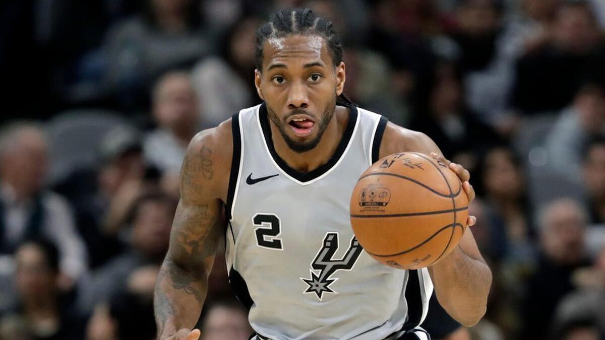 Kawhi Leonard moves the ball up court during the second half of a game between the San Antonio Spurs and the Denver Nuggets on Jan. 13.