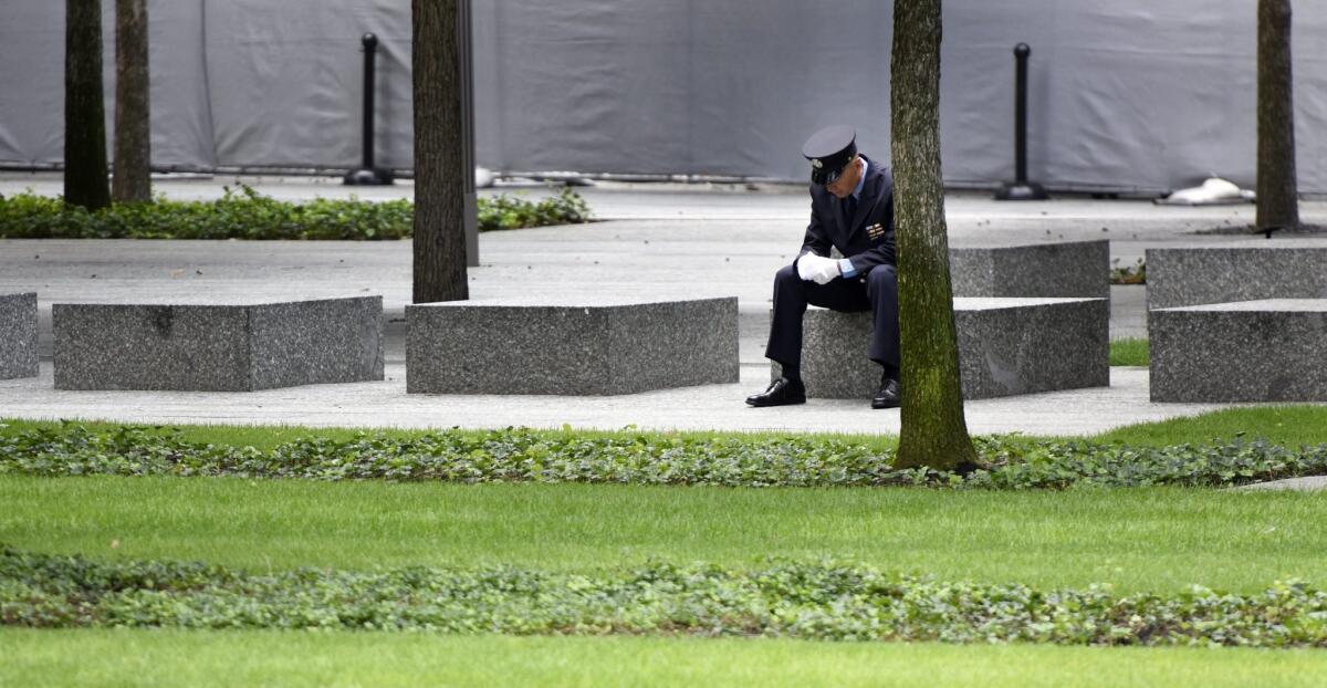 A firefighter listens as the names of victims of the 9/11 terror attacks are read Friday at the National September 11 Memorial in New York City.