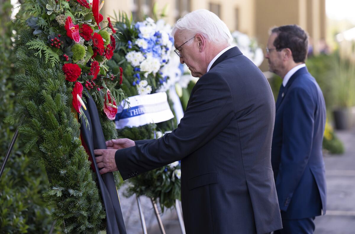 German President Frank-Walter Steinmeier, left, and Israeli President Isaac Herzog, right, attend a wreath laying ceremony to commemorate the victims of the attack by Palestinian militants on the 1972 Munich Olympics in Fuerstenfeldbruck near Munich, Germany, Monday, Sept. 5, 2002. The German and Israeli presidents are to join relatives of the 11 Israeli athletes killed in the attack by Palestinian militants on the commemoration event. (Sven Hoppe/dpa via AP)