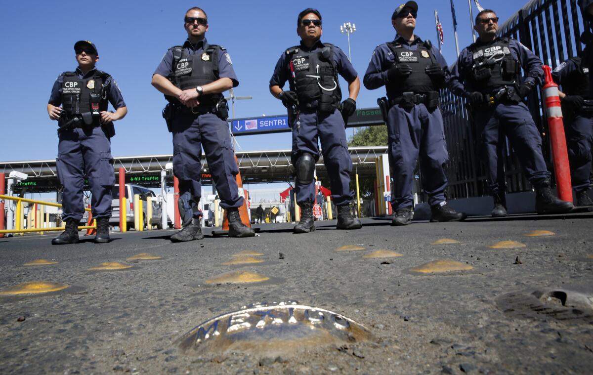 U.S. Customs and Border Protection officers span the northbound border crossing in Tijuana, Mexico, on March 10 as dozens of Mexican students and families who were deported from the U.S. plan to cross the border and apply for legal entry documents.