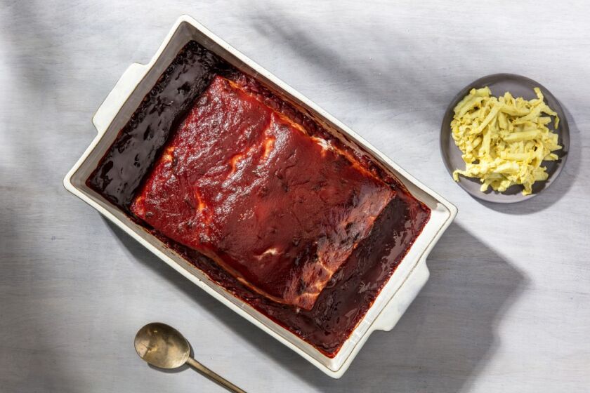 An old-fashioned Jewish-style brisket glaze, made with ketchup and red wine, flavors this slow-roasted side of salmon, served here with the side of Curry-Mustard Cabbage. Prop styling by Rebecca Buenik.