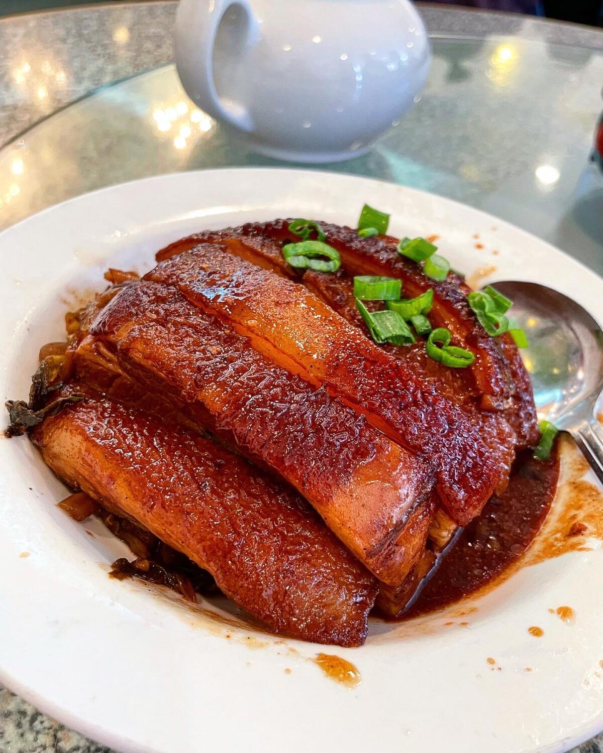 Pork belly topped with green onions.
