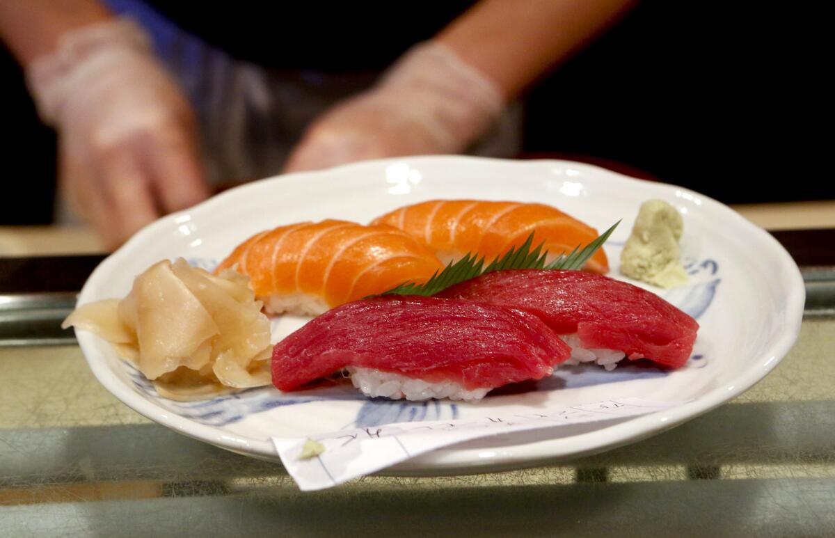 Gloves are worn to prepare sushi at Sushi Gen after a food safety law went into effect in California in January.
