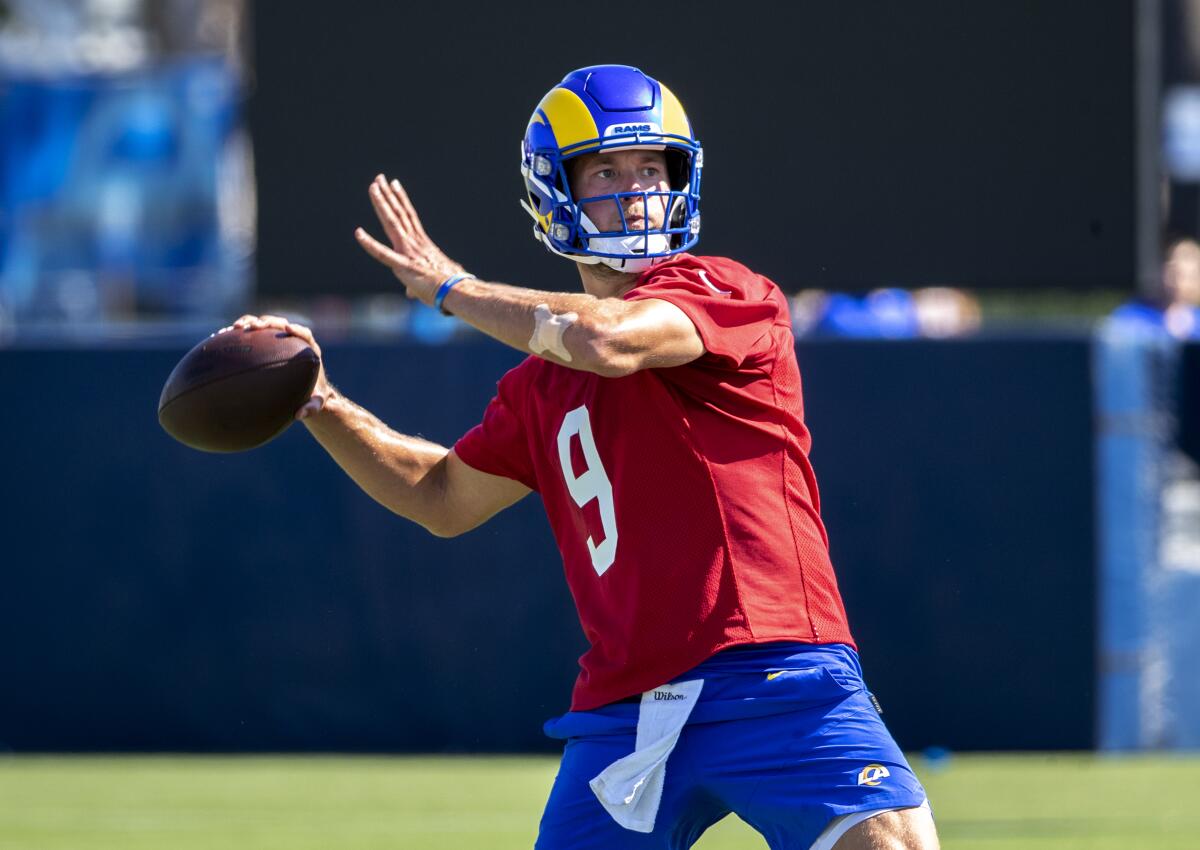  Rams starting quarterback Matthew Stafford throws a pass on the first day of training camp Wednesday at UC Irvine.