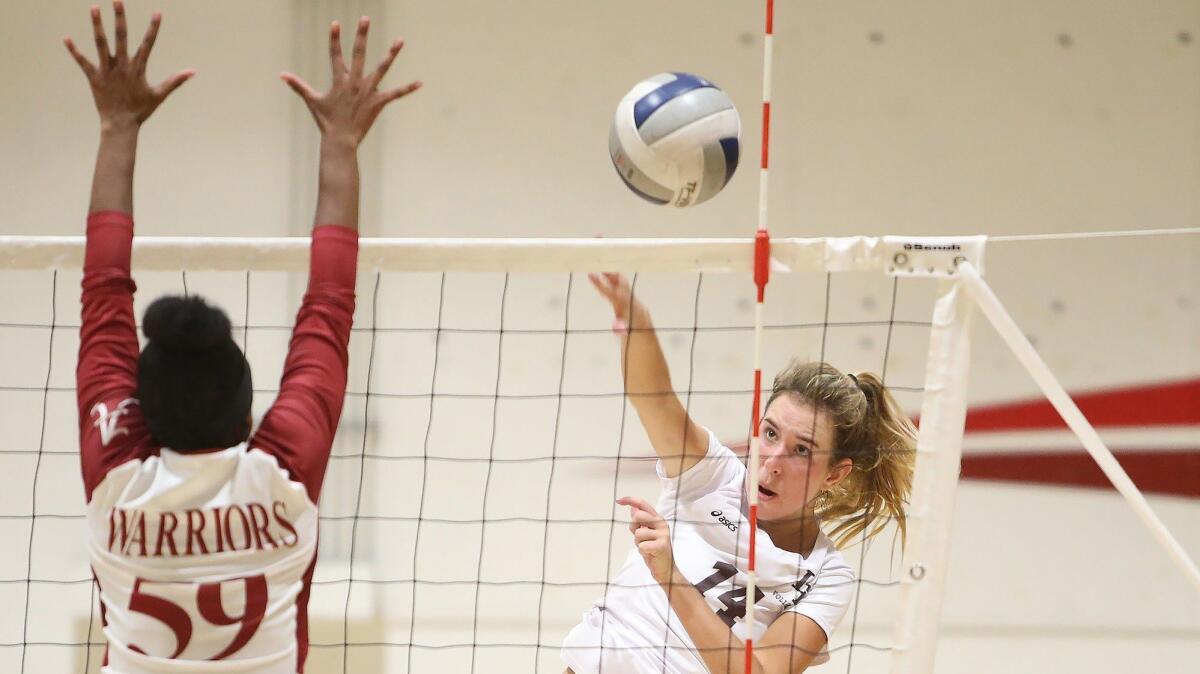 Laguna Beach High's Piper Naess puts a kill away past Mission Hills Alemany blocker Lindsey Felton in the quarterfinals of the CIF Southern Section Division 3 playoffs on Wednesday.