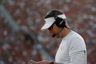 USC coach Lincoln Riley looks over his plays during a game against Washington State on Oct. 8, 2022 