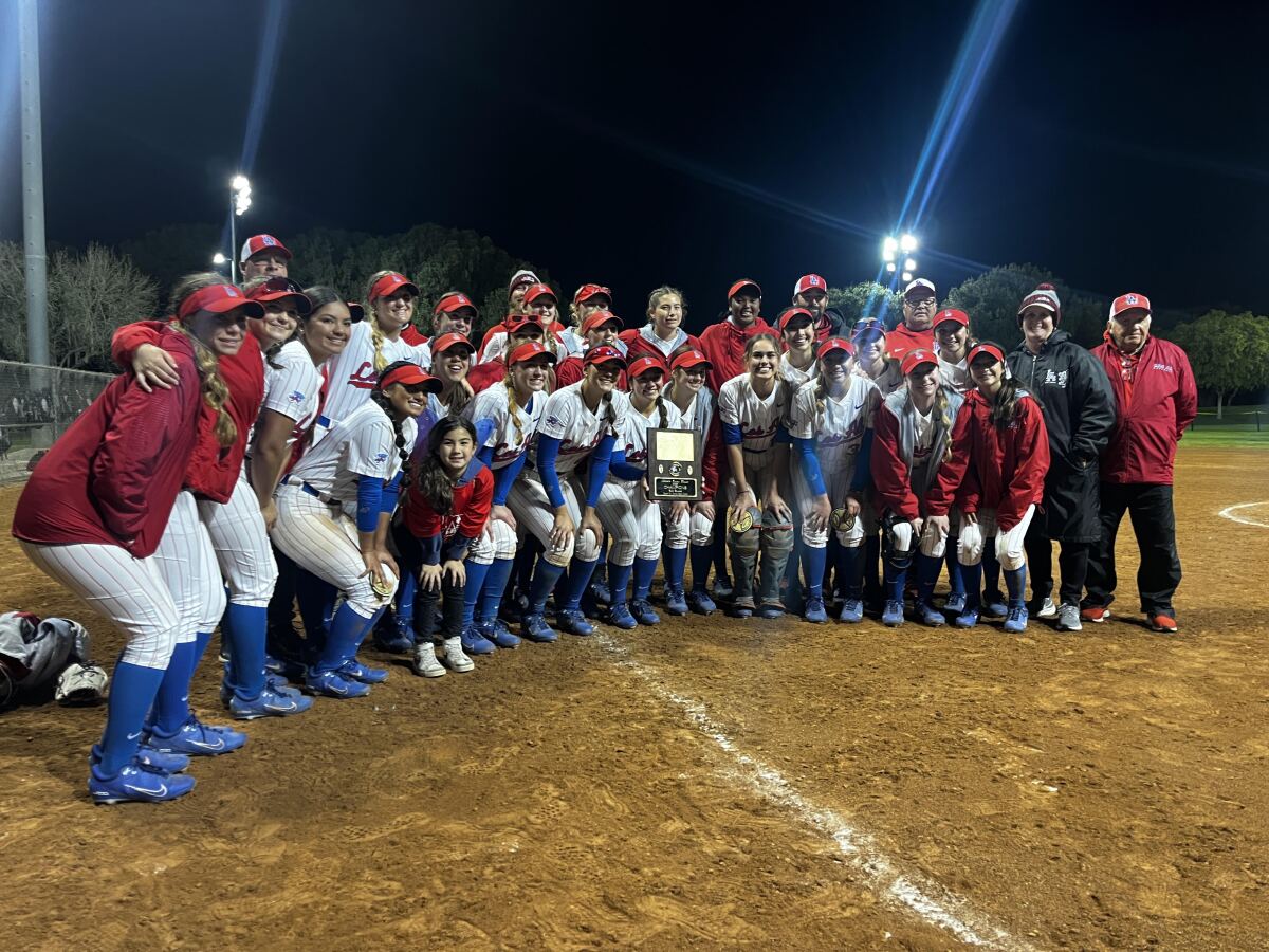 Los Alamitos softball celebrates after winning the Michelle Carew Classic on April 1, 2023.
