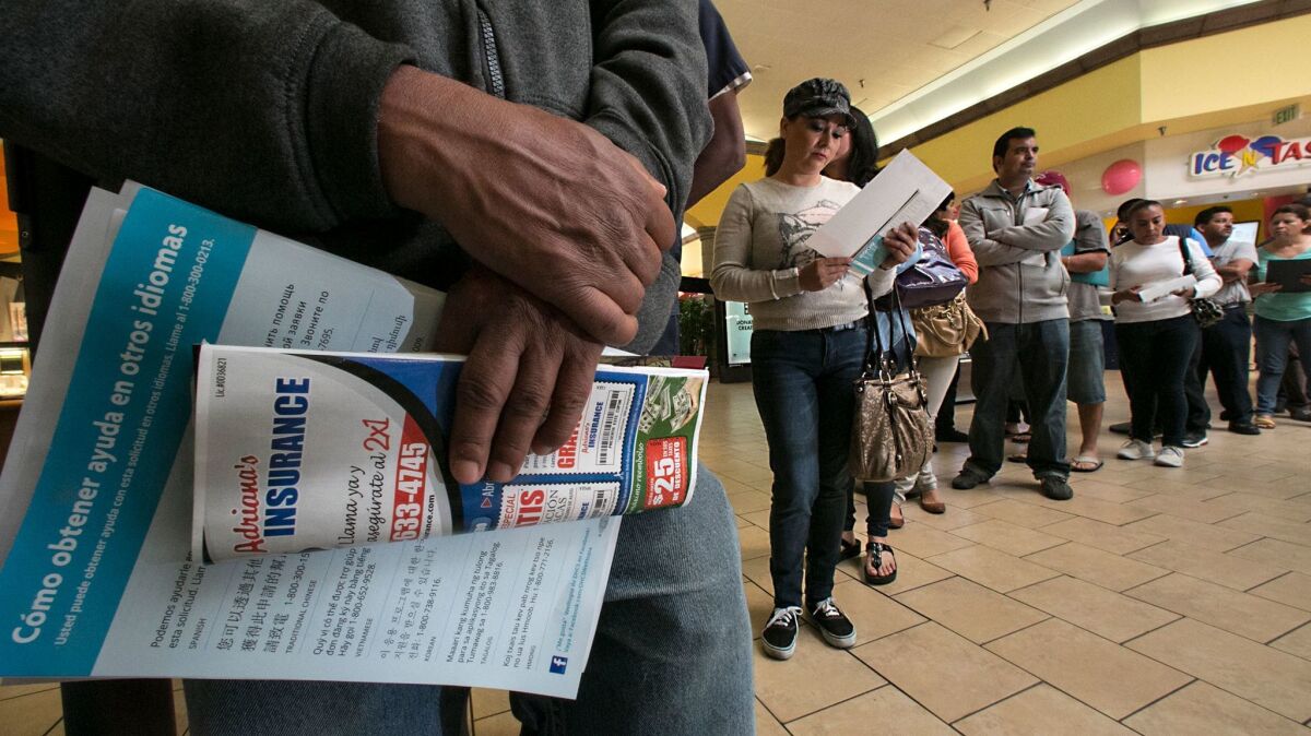 People line up at the Panorama Mall in Panorama City to sign up for Covered California ahead of a 2014 deadline.