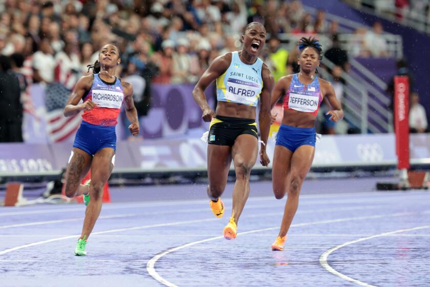 Julien Alfred, of Saint Lucia crosses the finish line ahead of Sha'carri Richardson and Melissa Jefferson