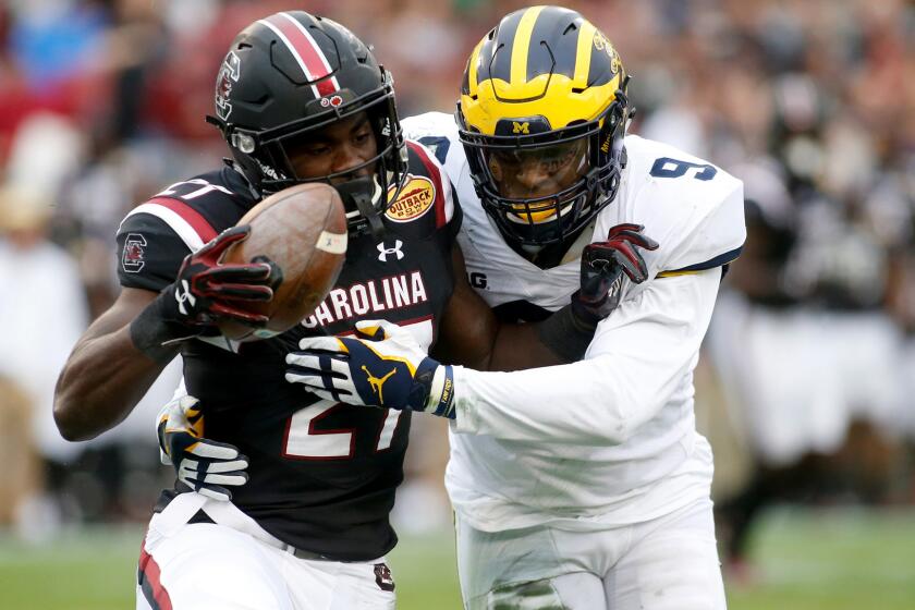 TAMPA, FL - JANUARY 1: Running back Ty'Son Williams #27 of the South Carolina Gamecocks is stopped by linebacker Mike McCray #9 of the Michigan Wolverines during the second quarter of the Outback Bowl NCAA college football game on January 1, 2018 at Raymond James Stadium in Tampa, Florida. (Photo by Brian Blanco/Getty Images) *** BESTPIX *** ** OUTS - ELSENT, FPG, CM - OUTS * NM, PH, VA if sourced by CT, LA or MoD **