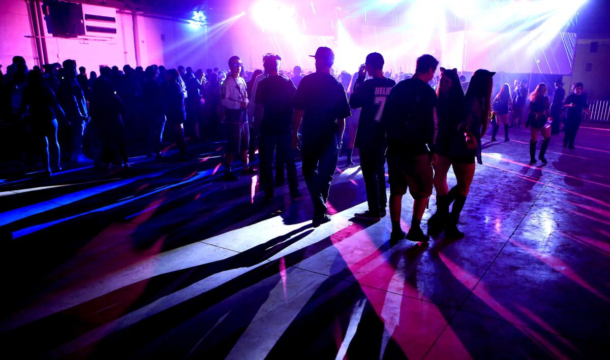 Electronic music fans dance during the first evening of the Hard Day of the Dead rave at Fairplex on Nov. 1, 2014 in Pomona. (Brian van der Brug / Los Angeles Times)