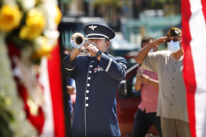 LOS ANGELES-CA-MAY 25, 2020: U.S. Air Force Senior Airman Allan Valladares with the 562nd Air National Guard Band of the West Coast, plays the trumpet at a Memorial Day ceremony at Los Cinco Puntos/Five Points Memorial in East Los Angeles on Monday, May 25, 2020. (Christina House / Los Angeles Times)