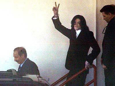 Michael Jackson gestures towards media