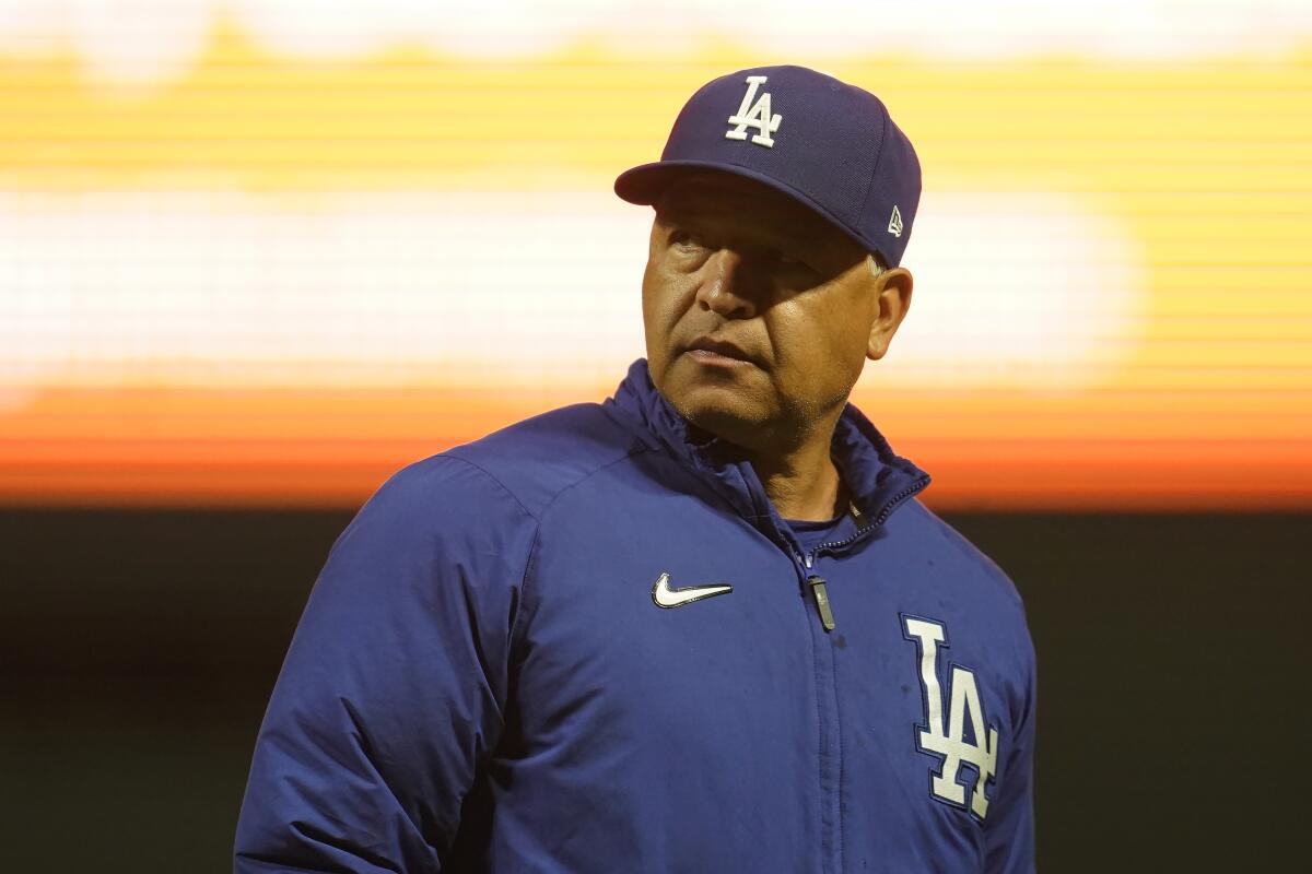 Dodgers manager Dave Roberts walks on the field during a game against the Giants in San Francisco on Sept. 17.