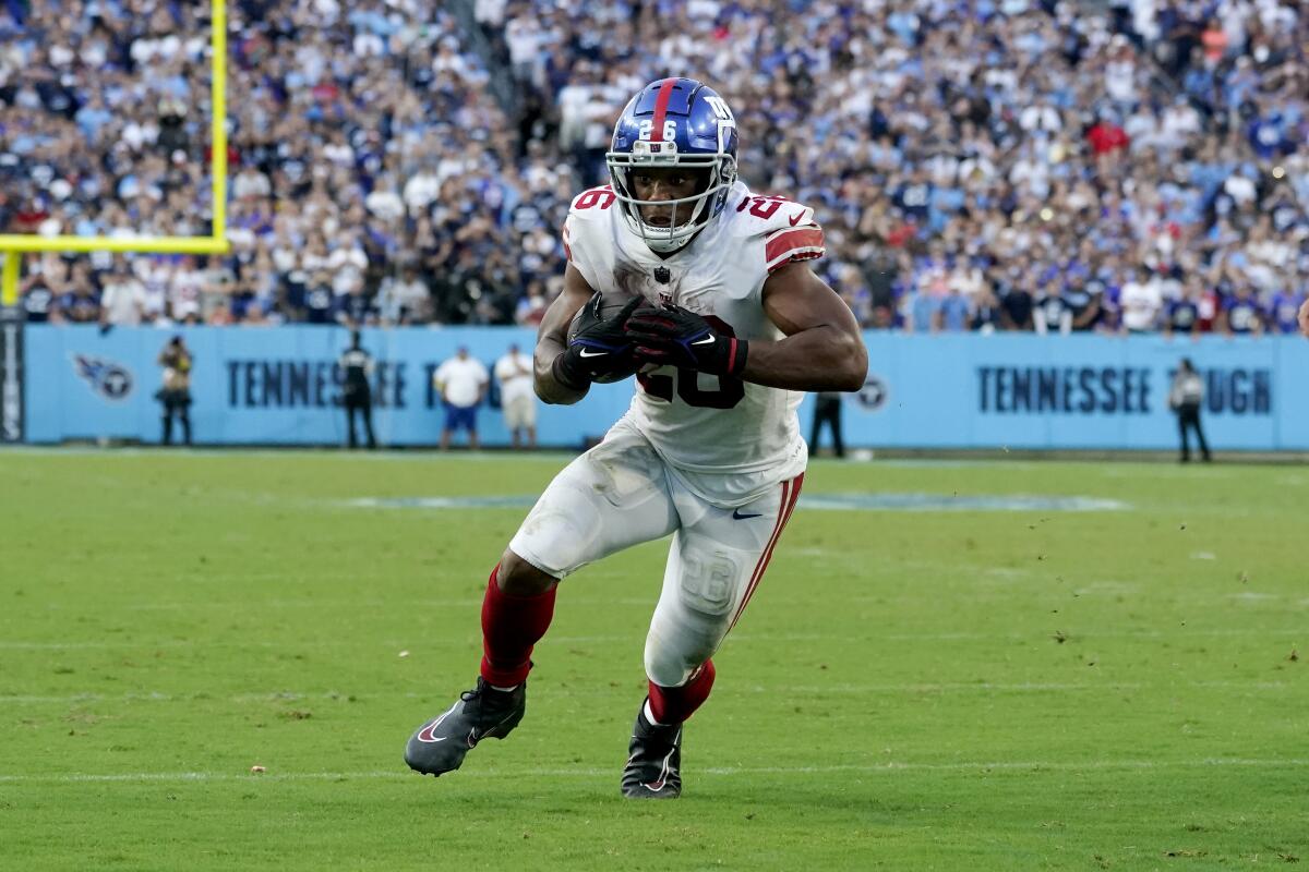 New York Giants running back Saquon Barkley scores on a two-point conversion against the Tennessee Titans.