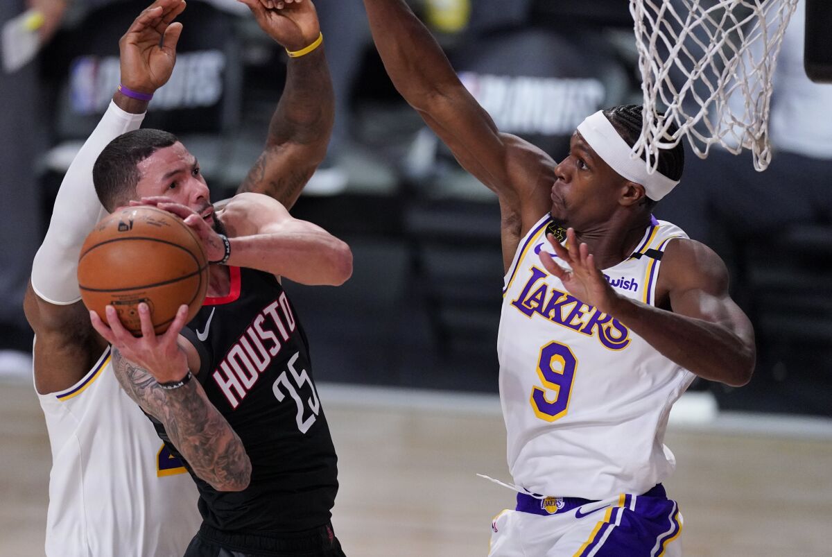 Lakers guard Rajon Rondo forces Rockets guard Austin Rivers into an awkward shot with his defense on Sept. 8, 2020.