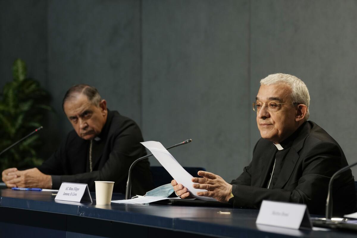 Mons. Filippo Iannone, right, and Mons. Juan Ignacio Arrieta Ochoa de Chinchetru hold a press conference to illustrate changes in the Church's Canon law, at the Vatican, Tuesday, June 1, 2021. Pope Francis has changed church law to explicitly criminalize the sexual abuse of adults by priests who abuse their authority and to say that laypeople who hold church office can be sanctioned for similar sex crimes. (AP Photo/Andrew Medichini)