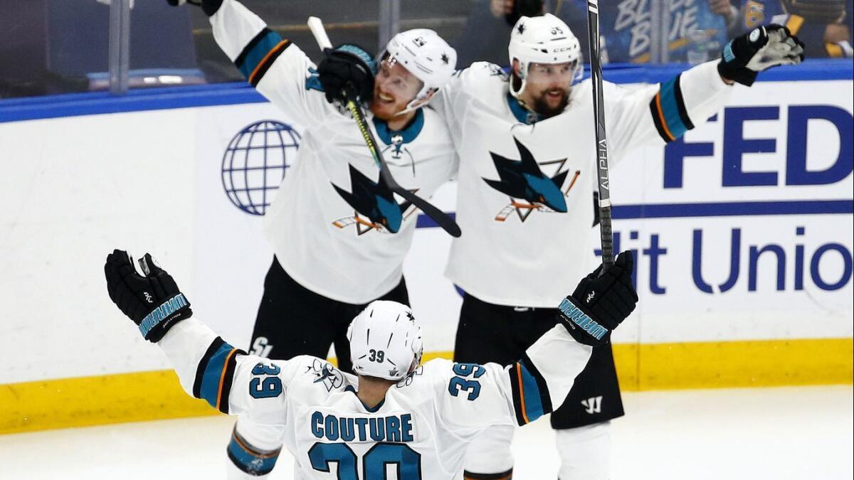 San Jose Sharks defenseman Erik Karlsson, top right, celebrates with his teammates after scoring the winning goal in overtime to defeat the St. Louis Blues in Game 3 of the Western Conference final.